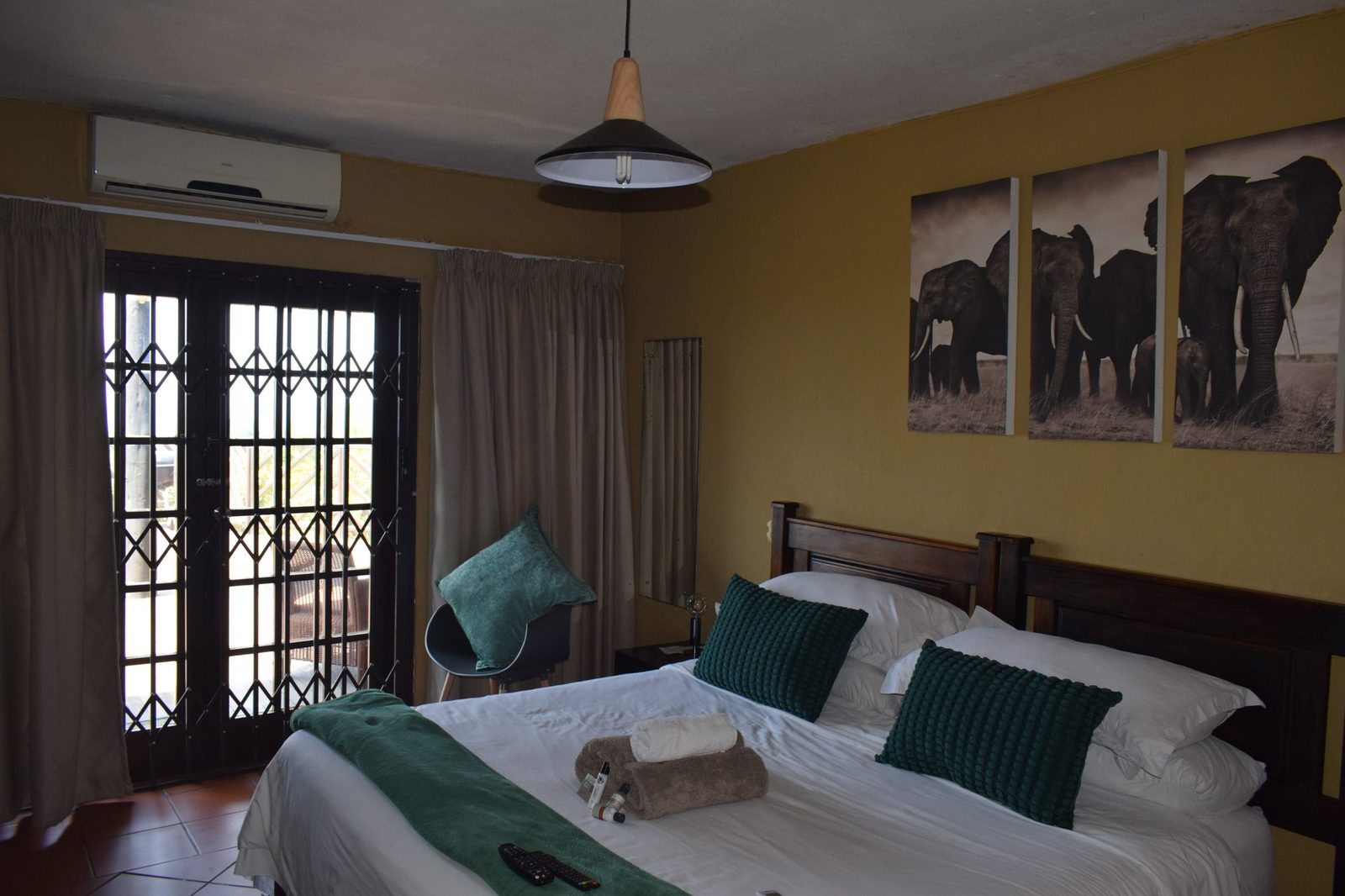 The Lodge king suite bedroom with French doors to the deck