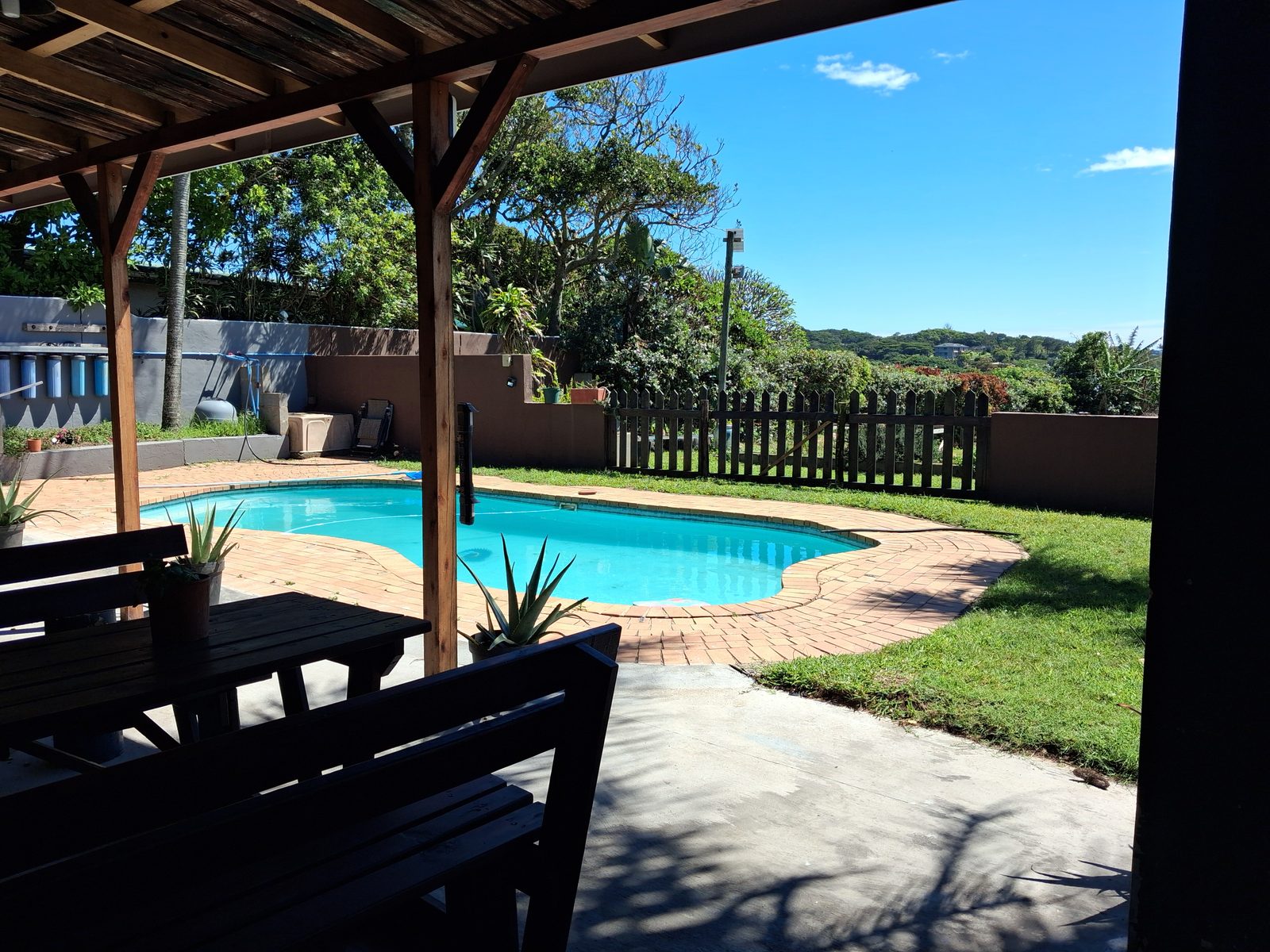 Cool by the pool: shaded seating beside the pool at the poolside rooms